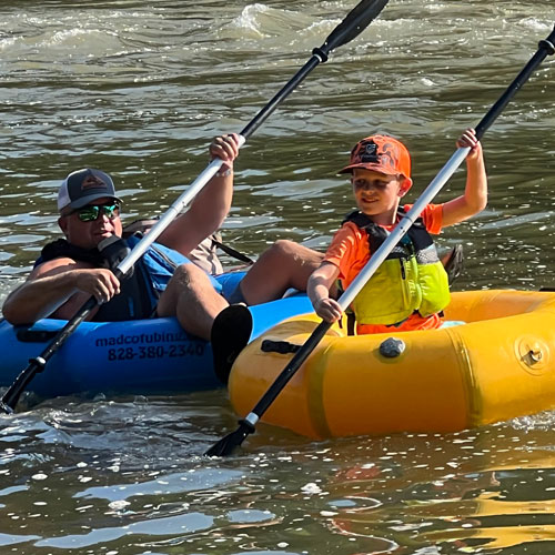 family preparing for Asheville tubing trip on the French Broad